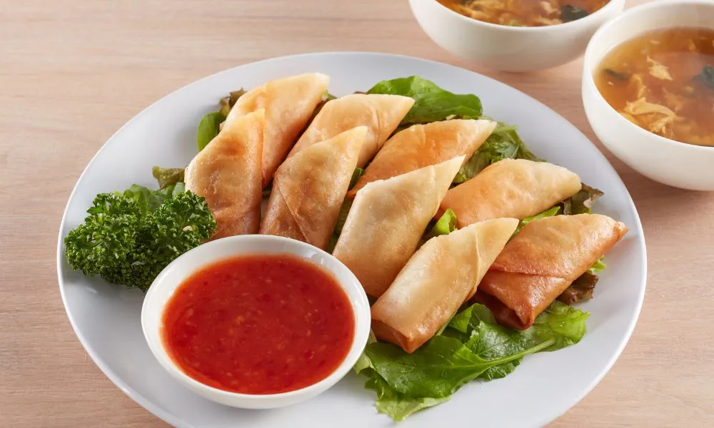 Golden fried spring rolls with sweet chili dipping sauce at Mingxia Dumpling, a Chinese Restaurant in Cordova