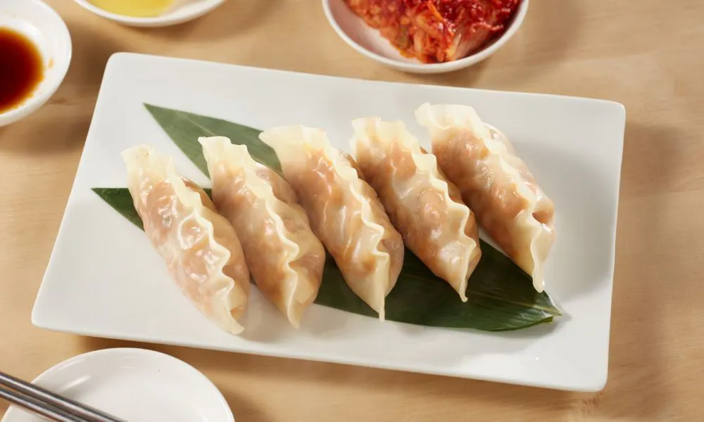 Pan-fried dumplings arranged on a green leaf at Mingxia Dumpling, a Chinese Restaurant in Cordova